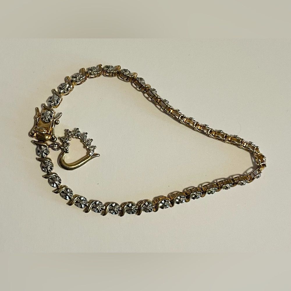 Gold over sterling silver Tennis bracelet with heart charm.